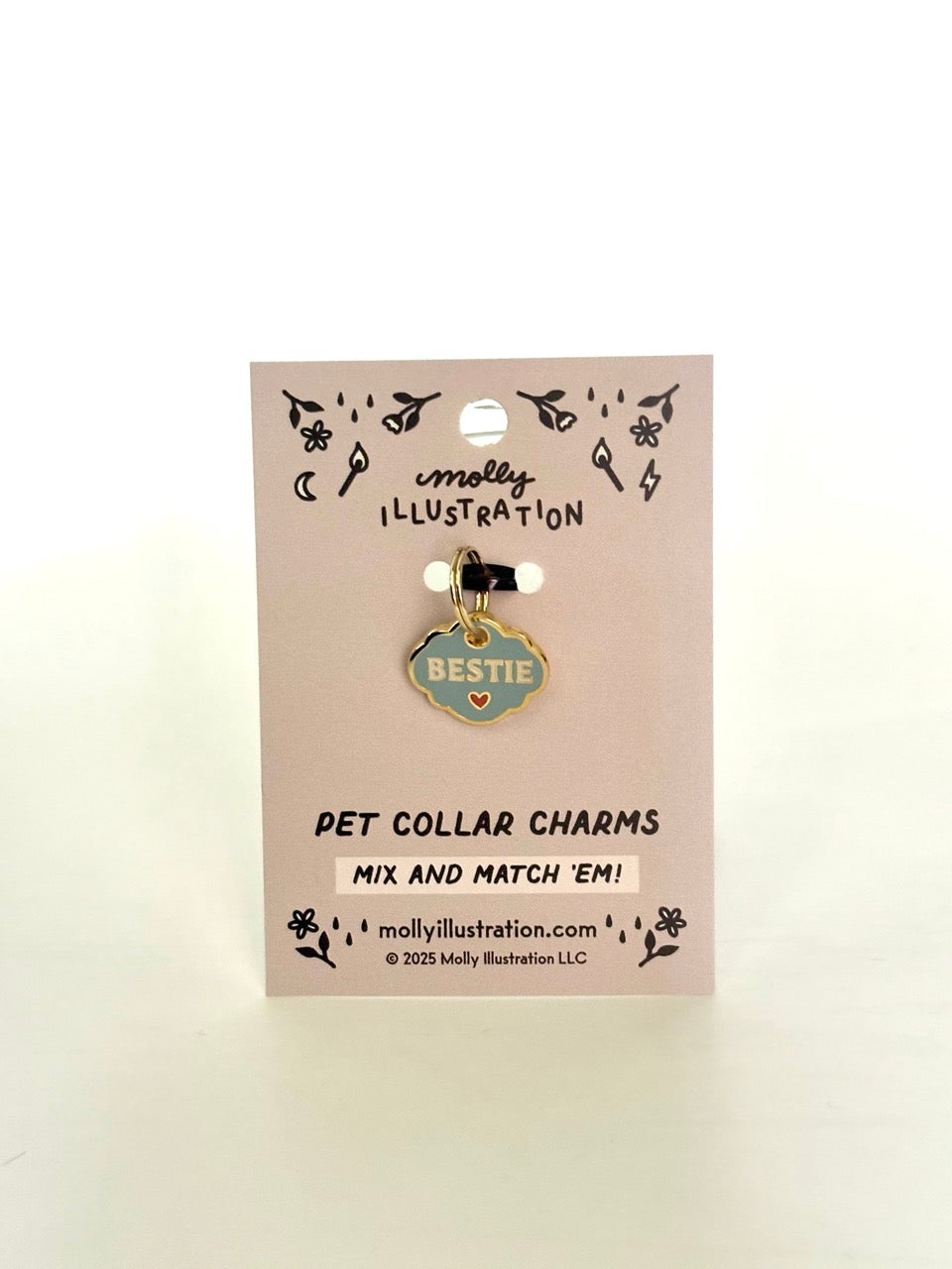 A hard enamel pet collar charm that reads “Bestie"