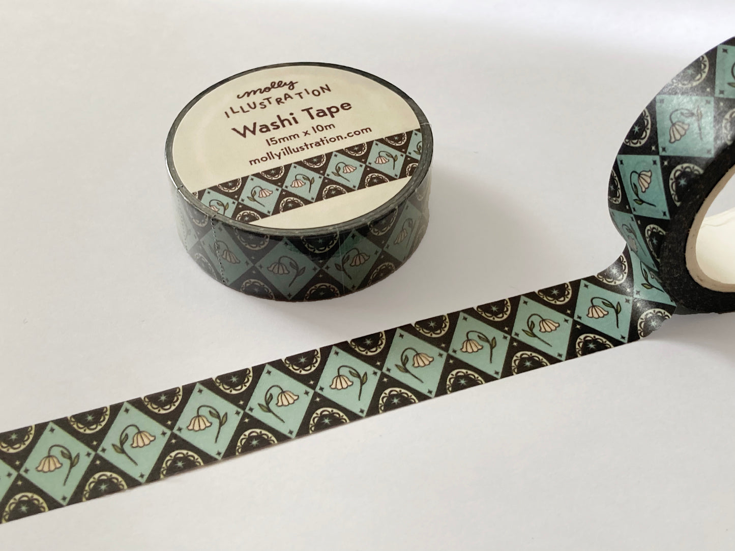 a vintage inspired illustrated washi tape with illustrated flowers in a geometric pattern