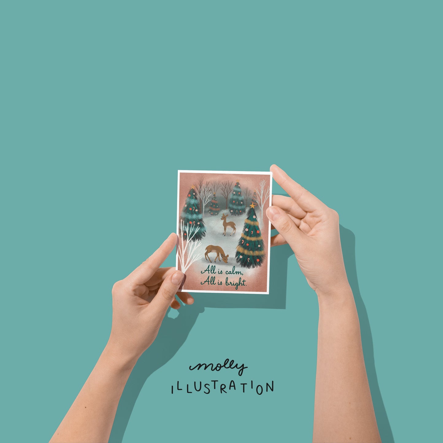 An illustrated holiday greeting card that reads “All is Calm, All is Bright” below a snowy christmas forest scene. There are two deer standing among many pine trees that are decorated with garlands and ornaments.