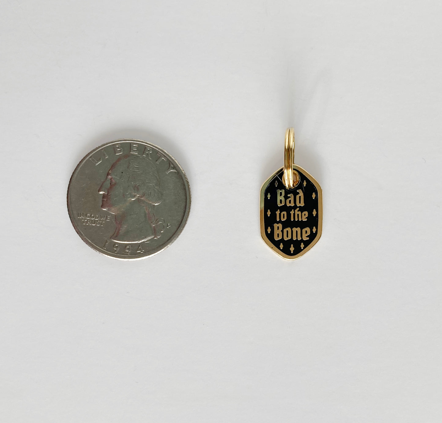 A hard enamel pet collar charm that reads “bad to the Bone”