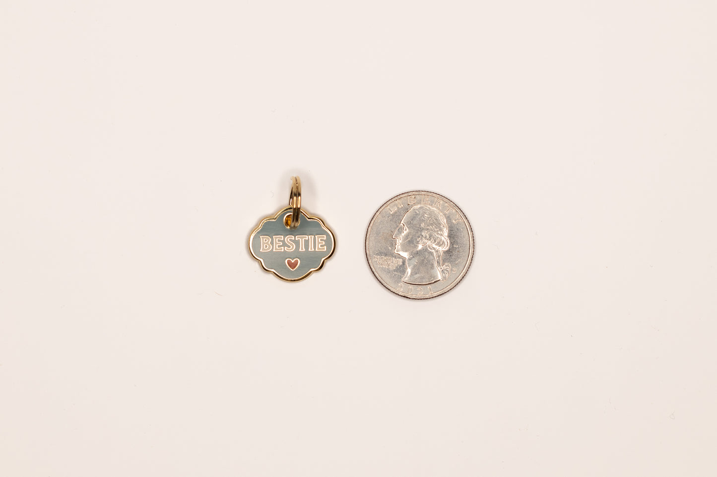 A hard enamel pet collar charm that reads “Bestie”