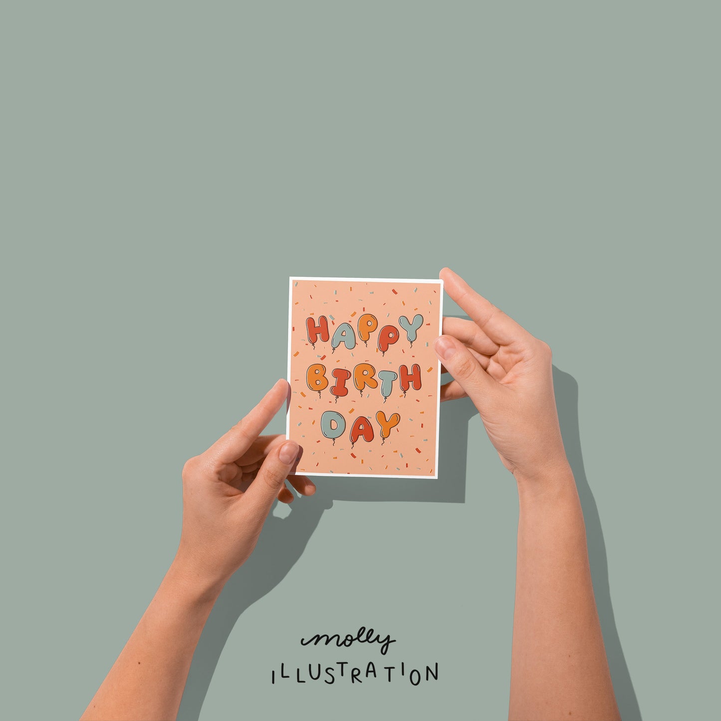 hands holding an illustrated greeting card that reads "happy birthday" spelled out in balloon letters.