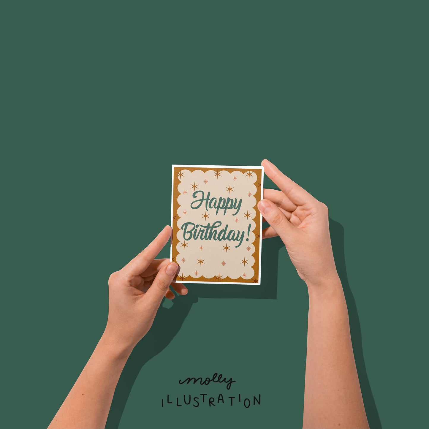 Hands Holding an illustrated greeting card that reads "Happy Birthday!" in script writing surrounded by dark gold sparkles.