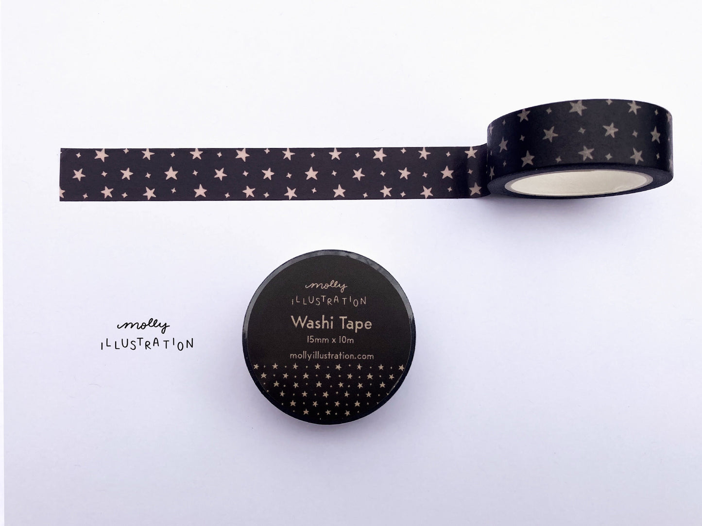 A roll of illustrated washi tape printed with off white stars over a black background.