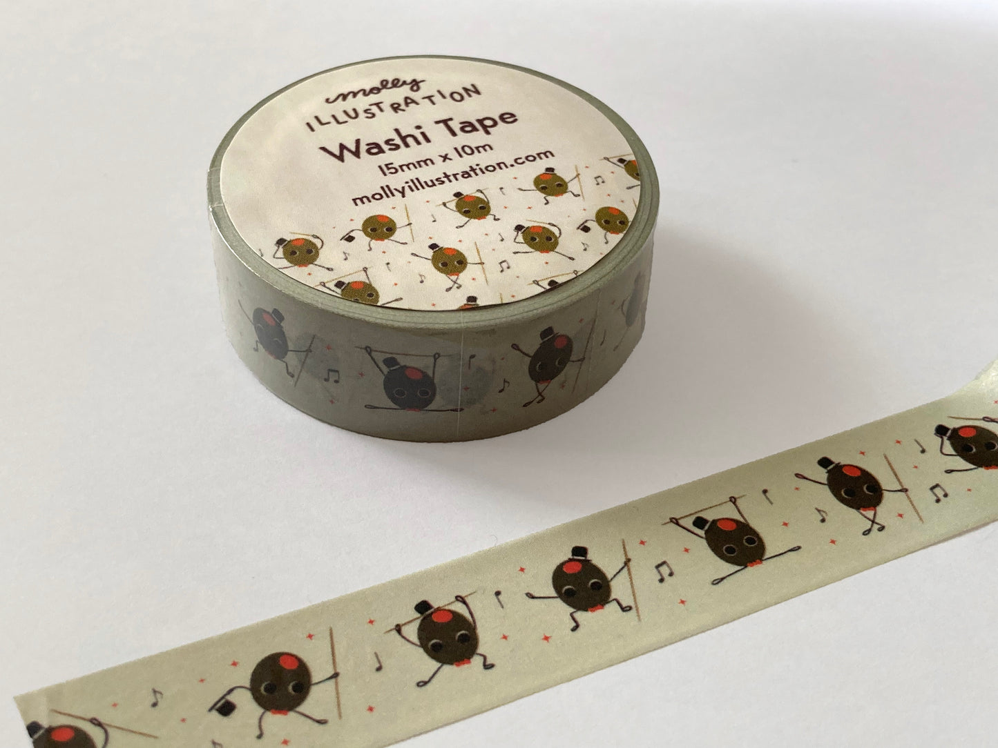 a vintage inspired illustrated washi tape of a cartoon olive that is dancing