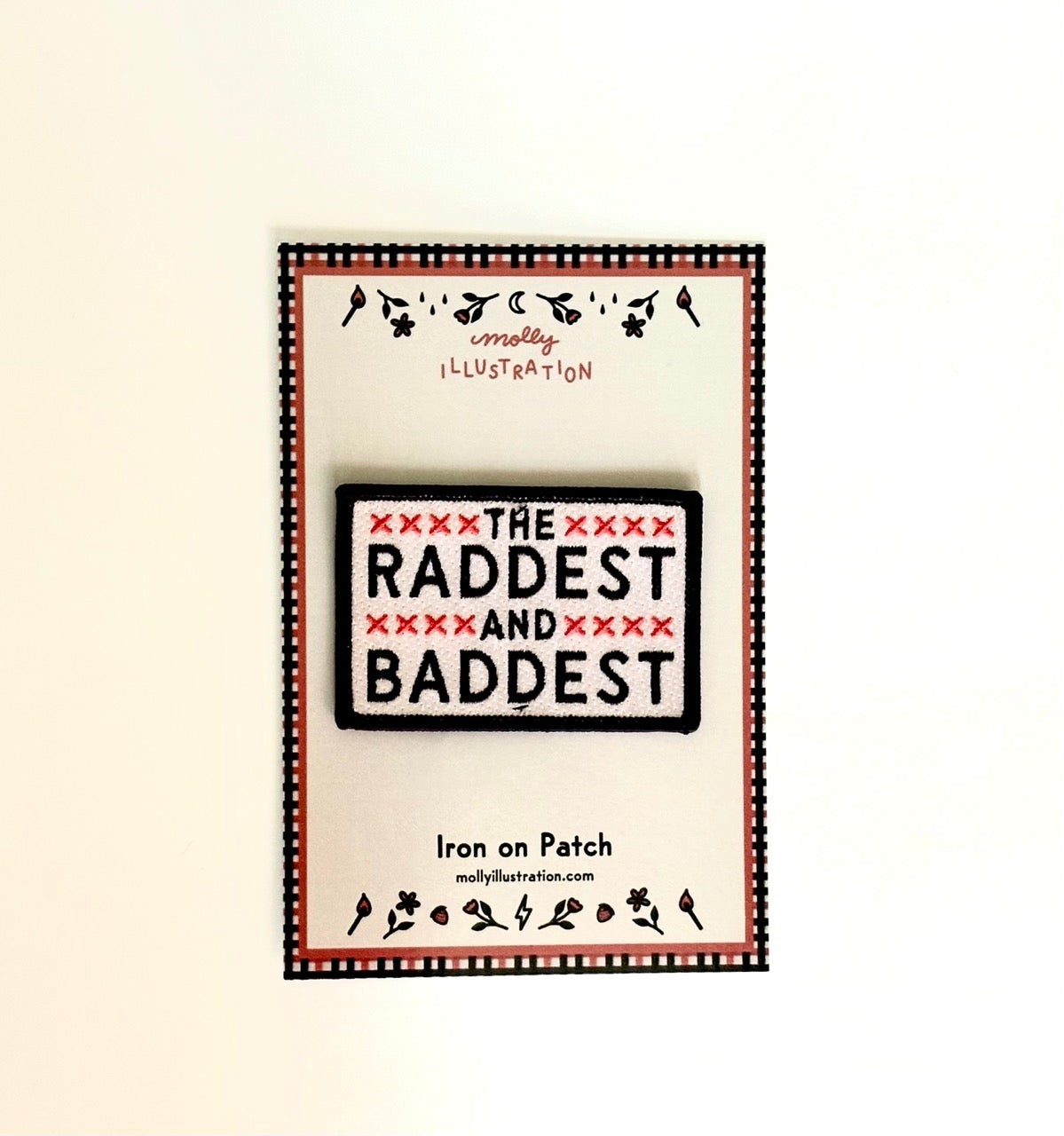 An embroidered iron on patch that reads the raddest and the baddest