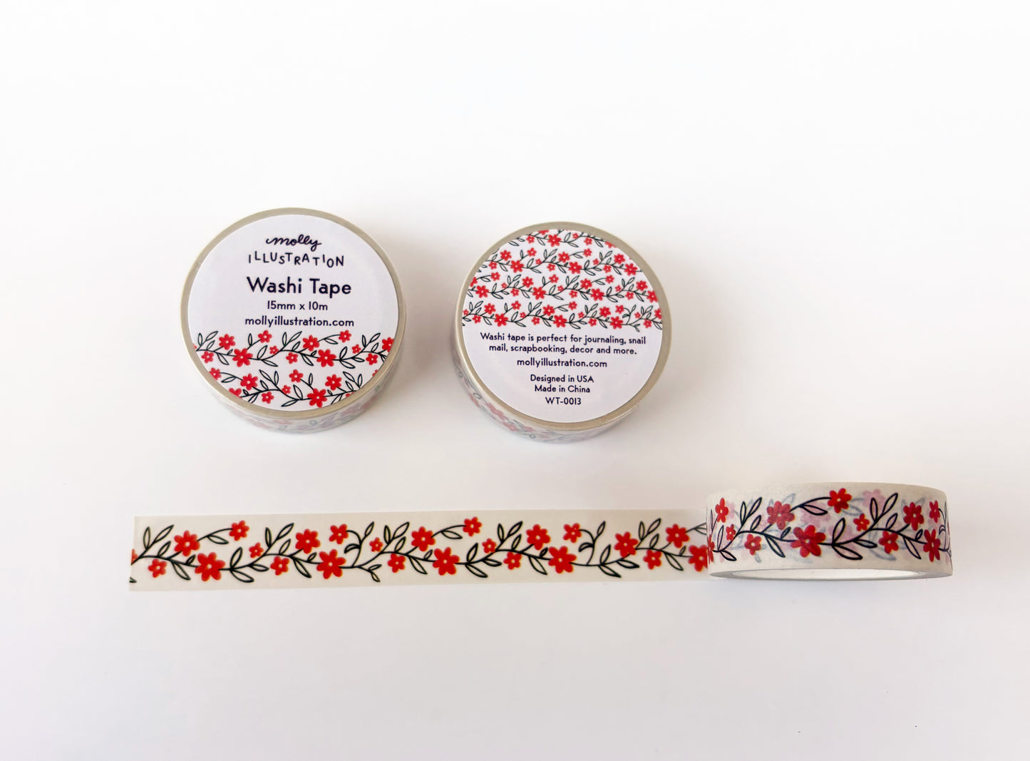 Two rolls of floral-patterned washi tape with a sample strip on a white background.