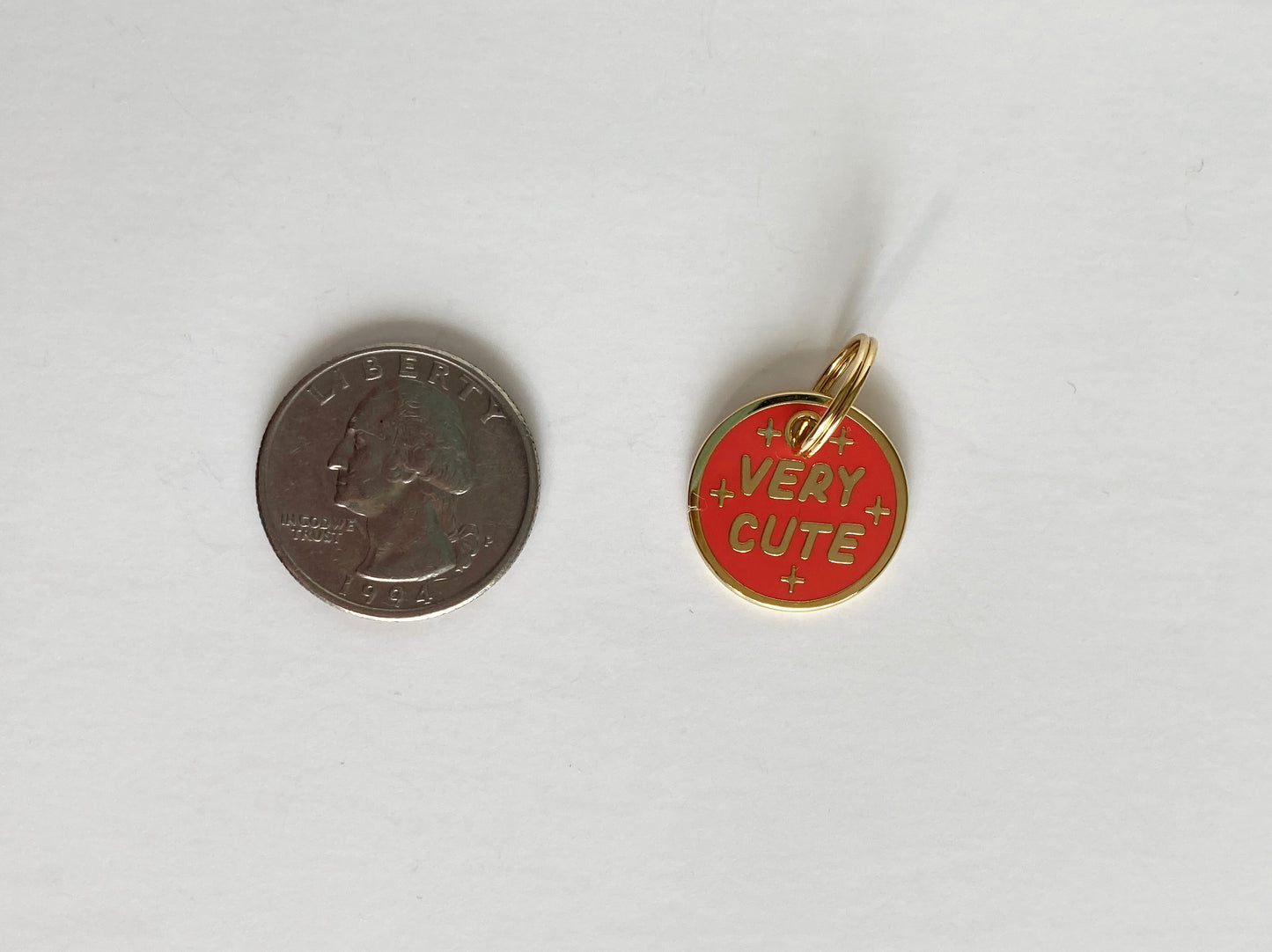 A hard enamel pet collar charm that reads “Very Cute”