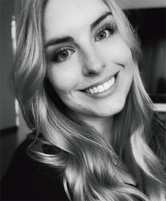 a black and white image of a woman smiling at the camera