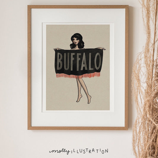 an illustrated art print of a cartoon pin up girl holding a flag over her torso that reads, Buffalo.
