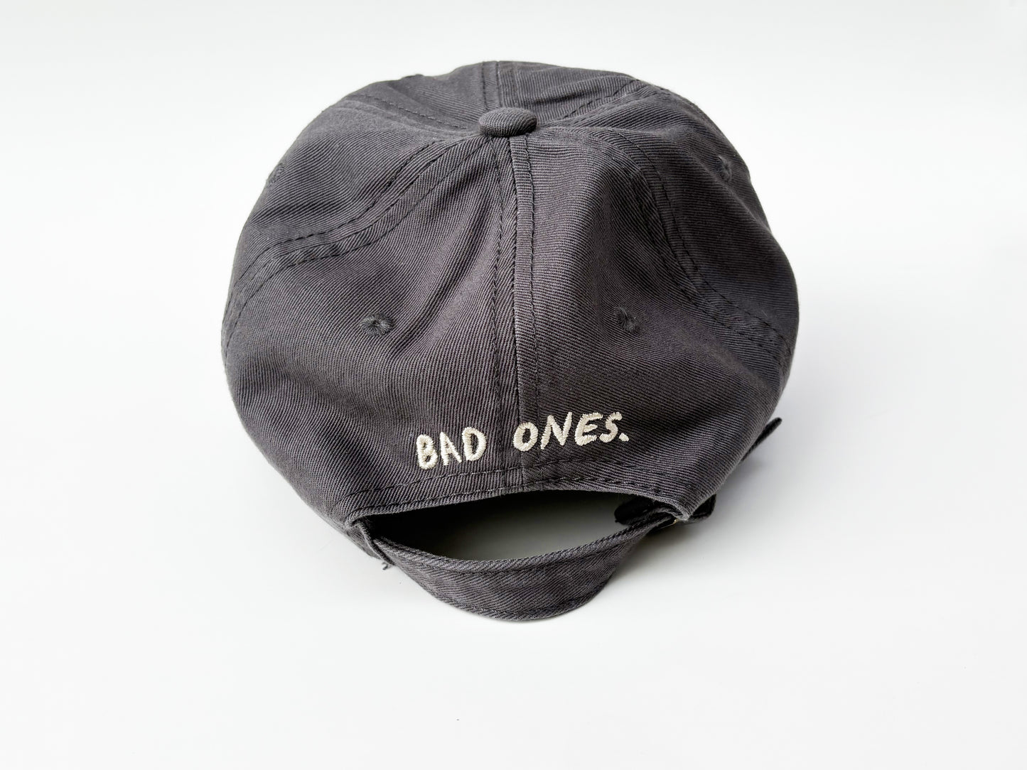 Gray cap with 'BAD ONES' text on a white background