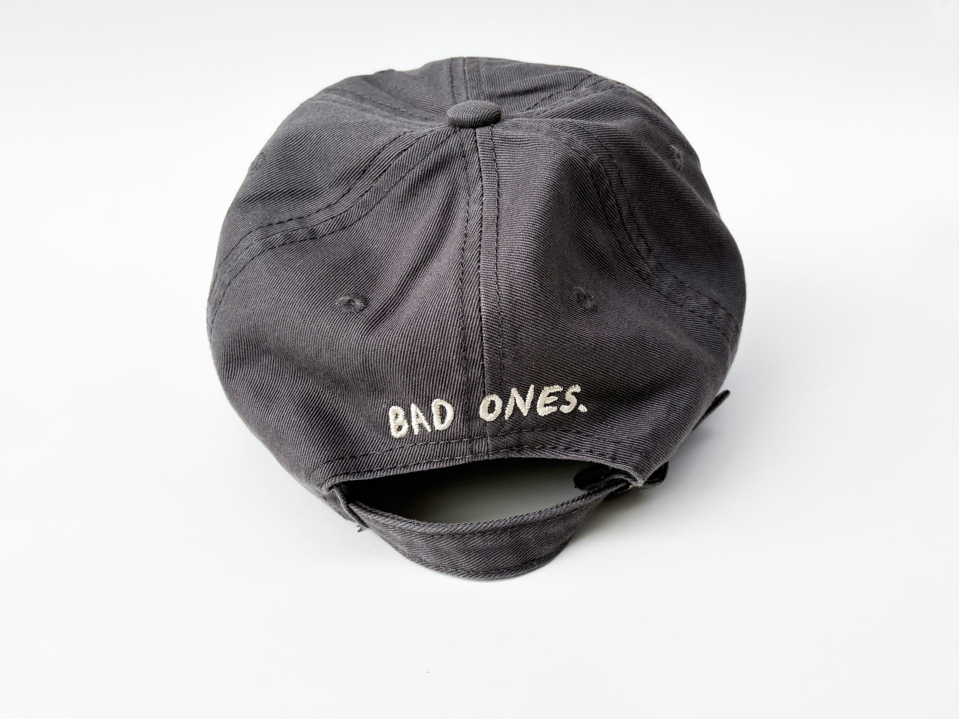 Gray cap with 'BAD ONES' text on a white background
