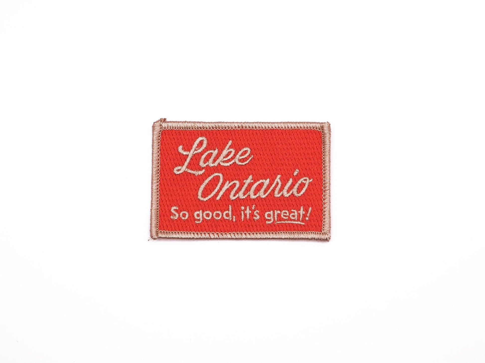 a red rectangular embroidered iron on patch that reads "Lake Ontario, So good, it's great!" in off white lettering.