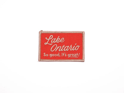 a red rectangular embroidered iron on patch that reads "Lake Ontario, So good, it's great!" in off white lettering.