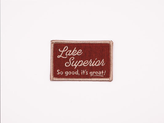 a burgundy rectangular embroidered iron on patch that reads "Lake Superior, So good, it's great!" 