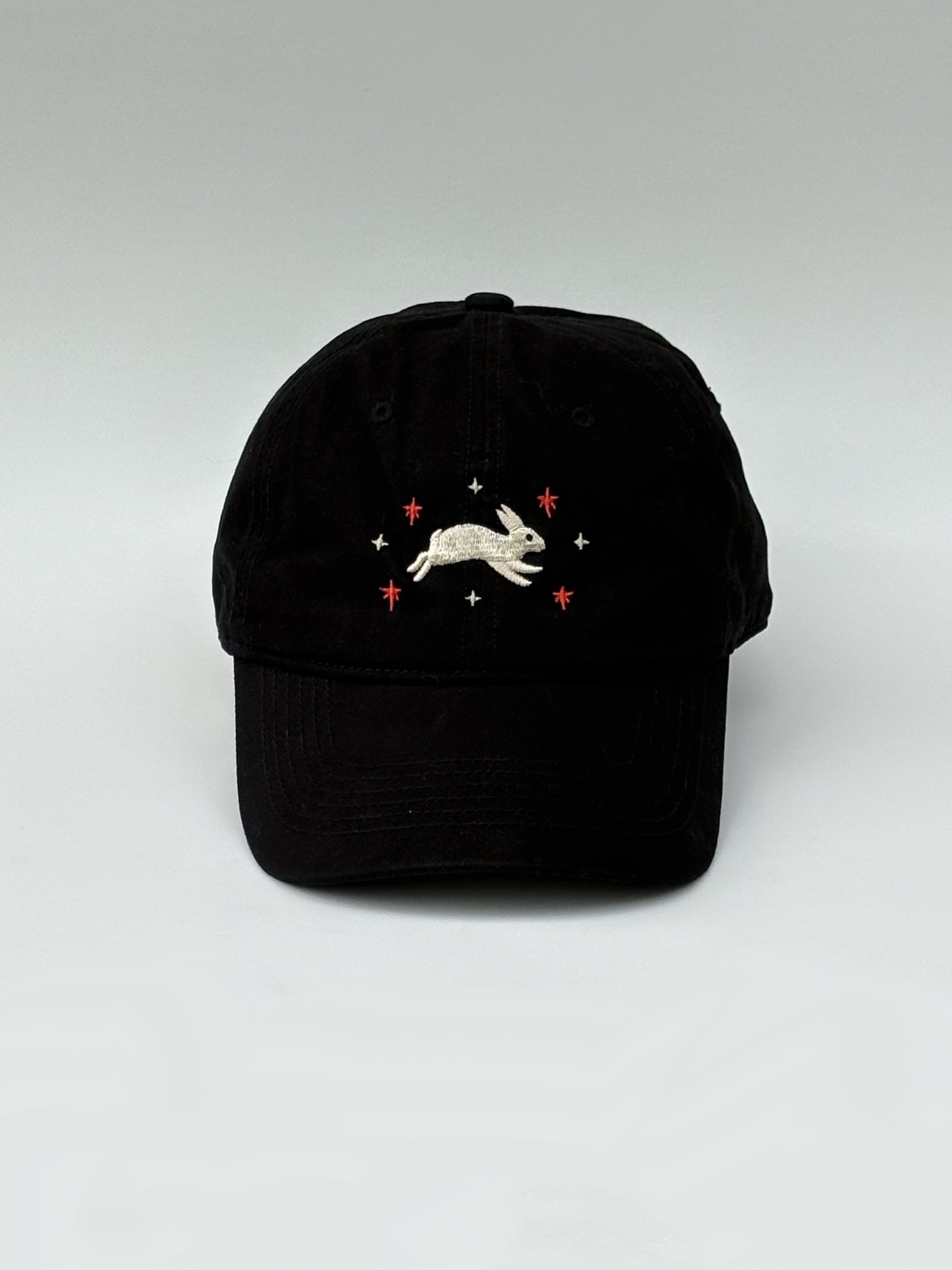 Black cap with embroidered design on a white background