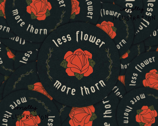  A vinyl sticker of a cartoon rose that reads "Less Flower More Thorn."