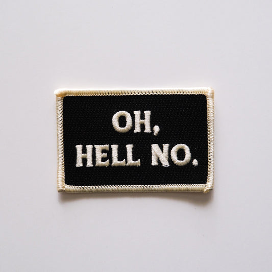 a black rectangular embroidered iron on patch that reads "Oh,Hello No." in off white lettering.