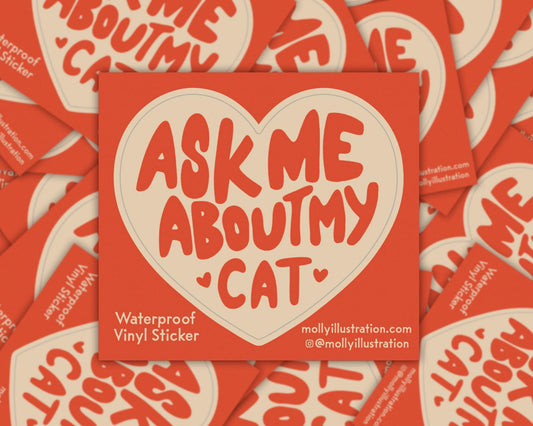 A kiss cut waterproof vinyl sticker in the shape of a heart that reads “ask me about my cat.”