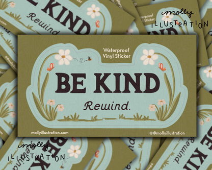 a kiss cut waterproof vinyl sticker that reads “Be kind, Rewind.” with flowers surrounding it.