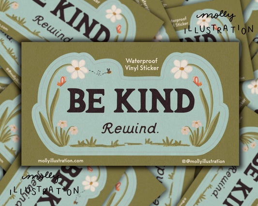 a kiss cut waterproof vinyl sticker that reads “Be kind, Rewind.” with flowers surrounding it.