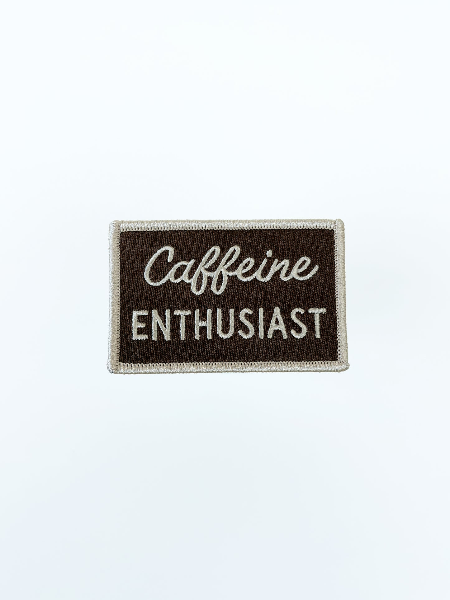 Patch with 'Caffeine Enthusiast' text on a brown background