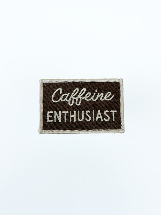 Patch with 'Caffeine Enthusiast' text on a brown background
