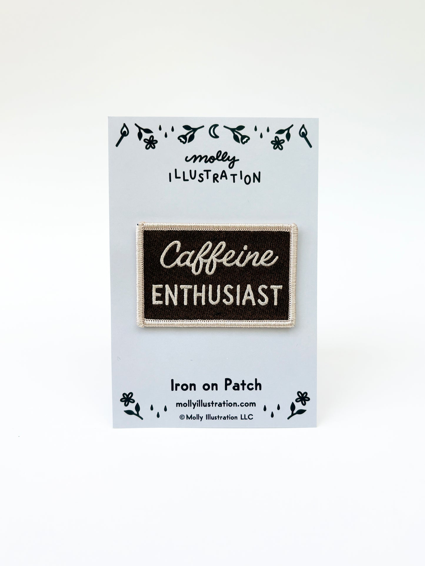 Iron on patch with 'Caffeine Enthusiast' text on a card with branding details.