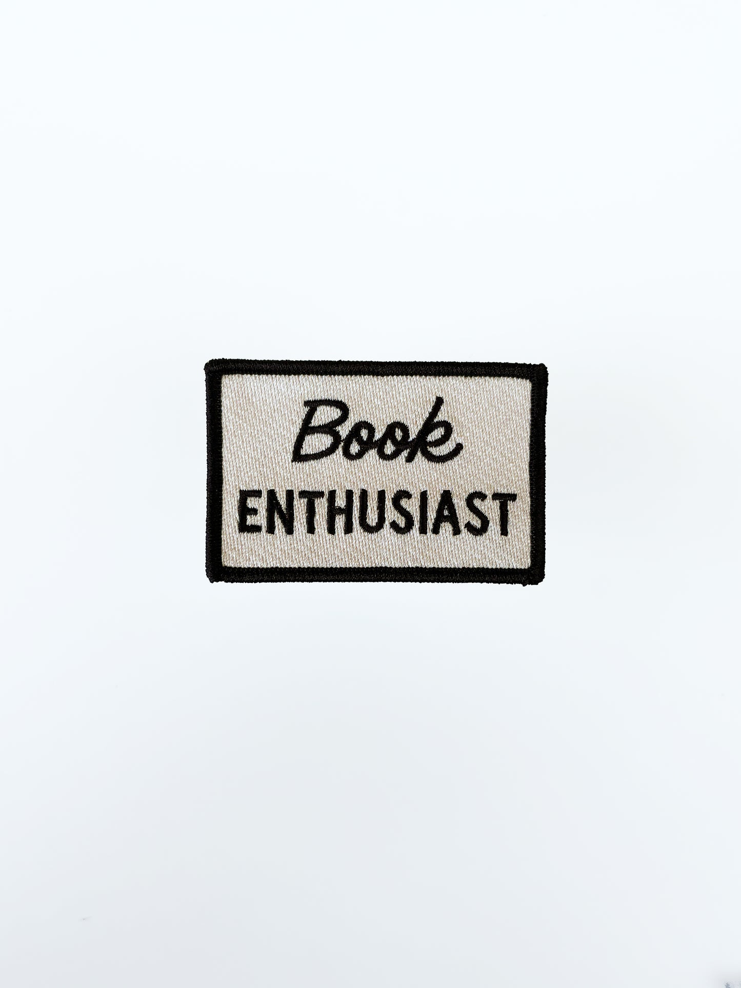 Patch with 'Book Enthusiast' text on a white background