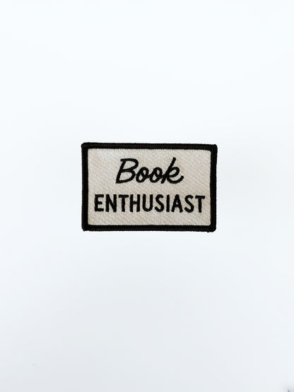 Patch with 'Book Enthusiast' text on a white background