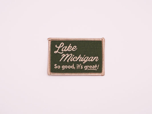 a green rectangular embroidered iron on patch that reads "Lake Michigan, So good, it's great!" in off white lettering.