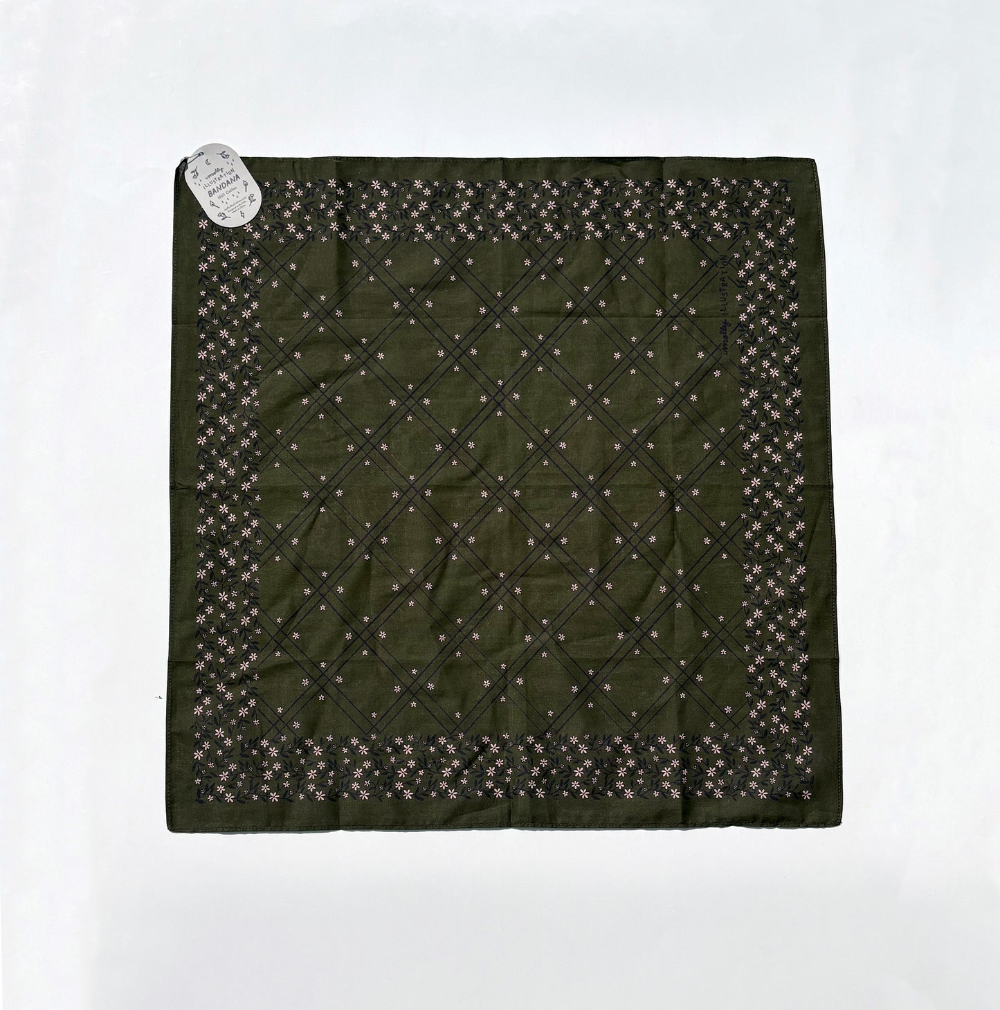 An olive green square scarf with a diamond-quilted center and a border of small floral motifs, laid flat on a white background with a small paper tag attached.