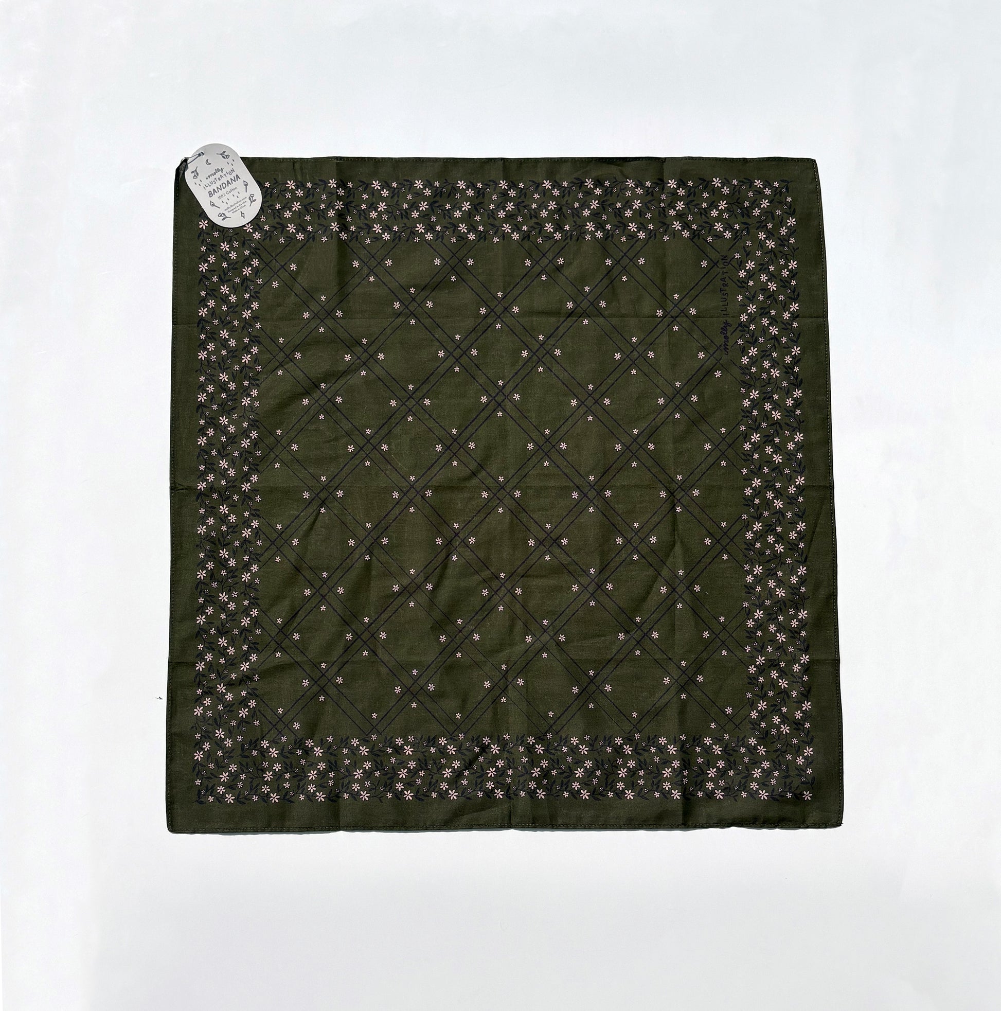An olive green square scarf with a diamond-quilted center and a border of small floral motifs, laid flat on a white background with a small paper tag attached.