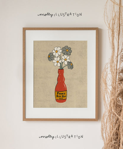 an illustrated art print of a frank's red hot sauce bottle that has daisies in it.