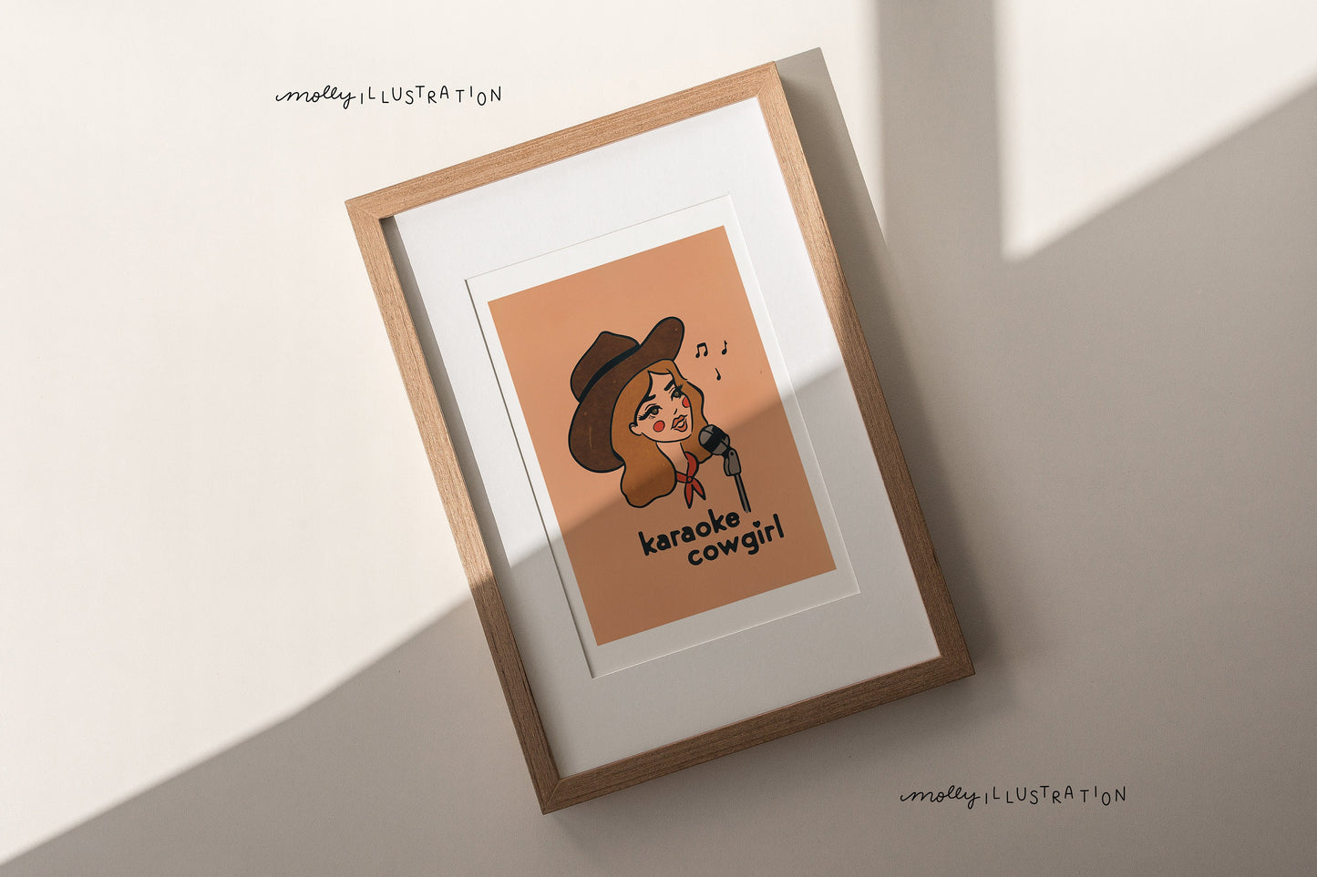 an art print of a cartoon cowgirl singing into a microphone. beneath her reads "karaoke cowgirl"