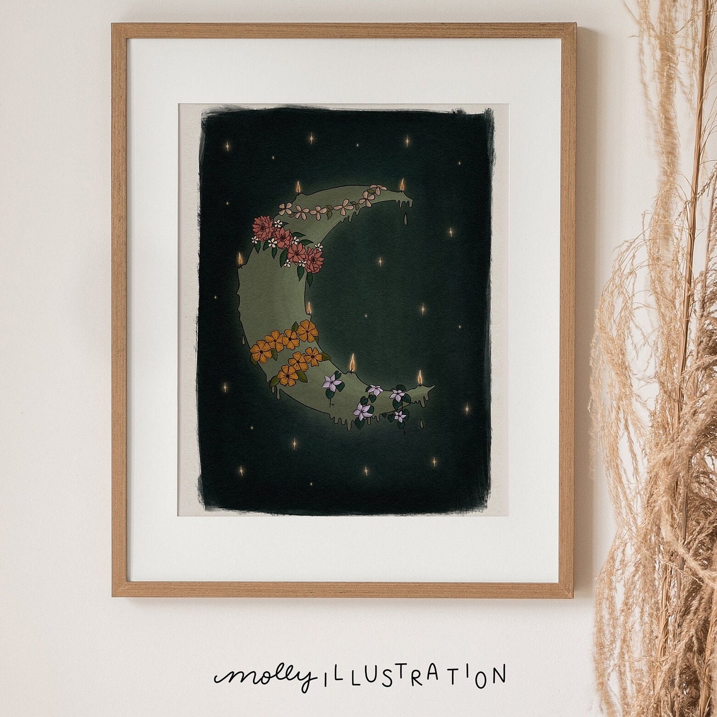 an art print of a painted crescent moon that is lit in multiple places like a candle. it is over a dark blue green starry background and the moon is wrapped in various flower garlands.