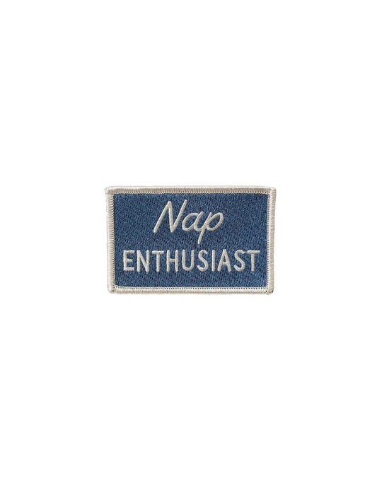 a blue patch that reads Nap Enthusiast on a white background