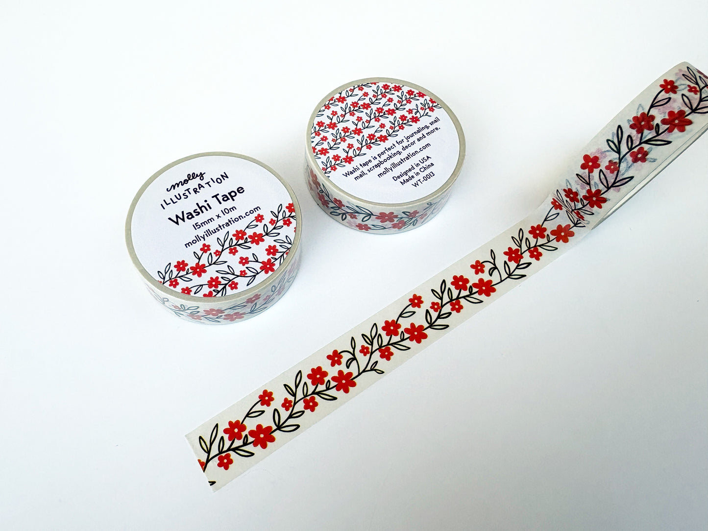 Two rolls of washi tape with floral designs on a white background
