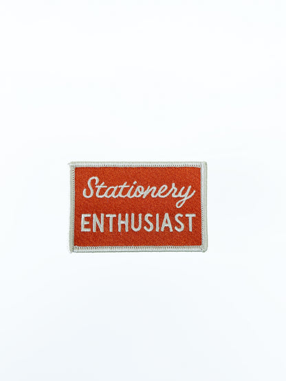 "Stationery Enthusiast" red patch on a white background