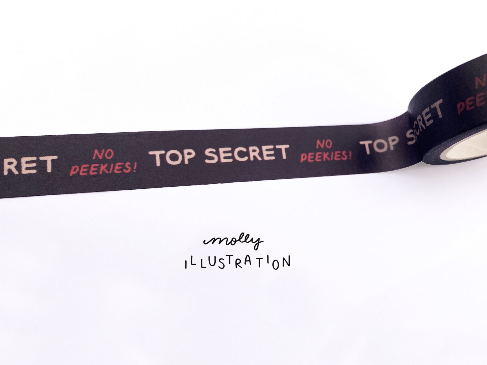 A roll of illustrated washi tape printed with the phrase “Top secret, No peekies!”