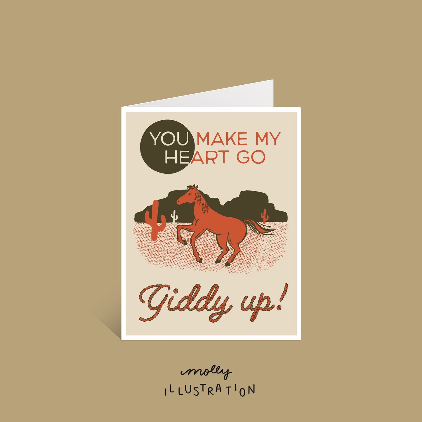 an illustrated vertical greeting card that shows a red and green desert scene and rearing horse. it reads "you make my heart go giddy up!"