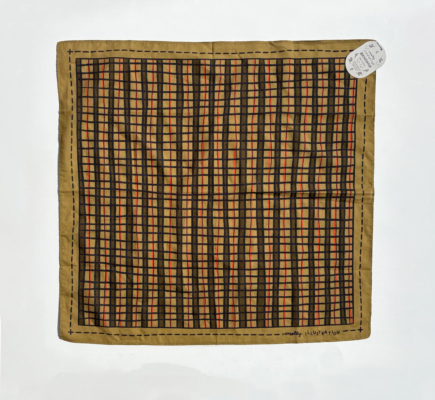 A vintage square scarf laid flat on a white background, featuring a tan border and a central black and orange checkered grid pattern. A small white paper tag is attached to the top right corner.